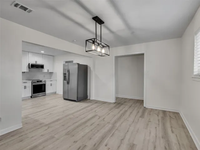 a view of a kitchen with a sink wooden floor and a window