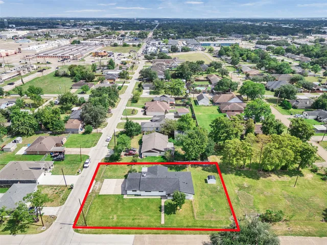 an aerial view of multiple houses with yard