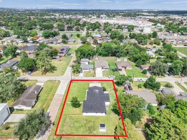 an aerial view of residential houses with outdoor space and street view
