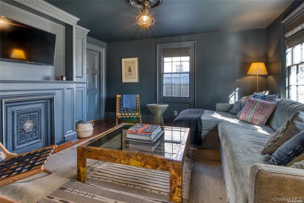 1800 Village Lane Orient, NY 11957 - Photo 9 of 12 Living room featuring healthy amount of natural light and a fireplace