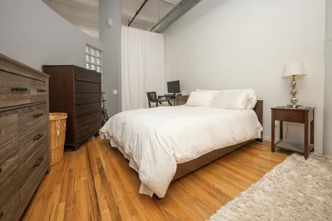 a bedroom with a bed and a mirror