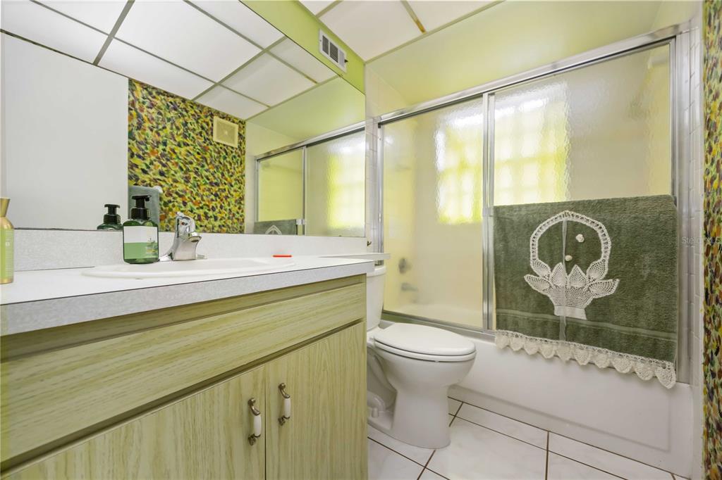 3801 Chinaberry Road Bradenton, FL 34208 - Photo 12 of 31 a bathroom with a sink a toilet and shower