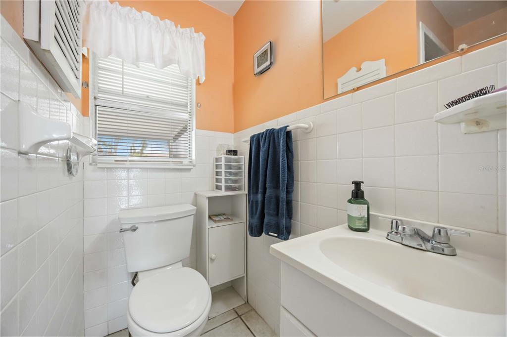 3801 Chinaberry Road Bradenton, FL 34208 - Photo 19 of 31 a white toilet sitting next to a bathroom sink