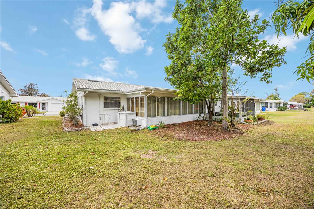 3801 Chinaberry Road Bradenton, FL 34208 - Photo 25 of 31 a view of a house with backyard porch and sitting area