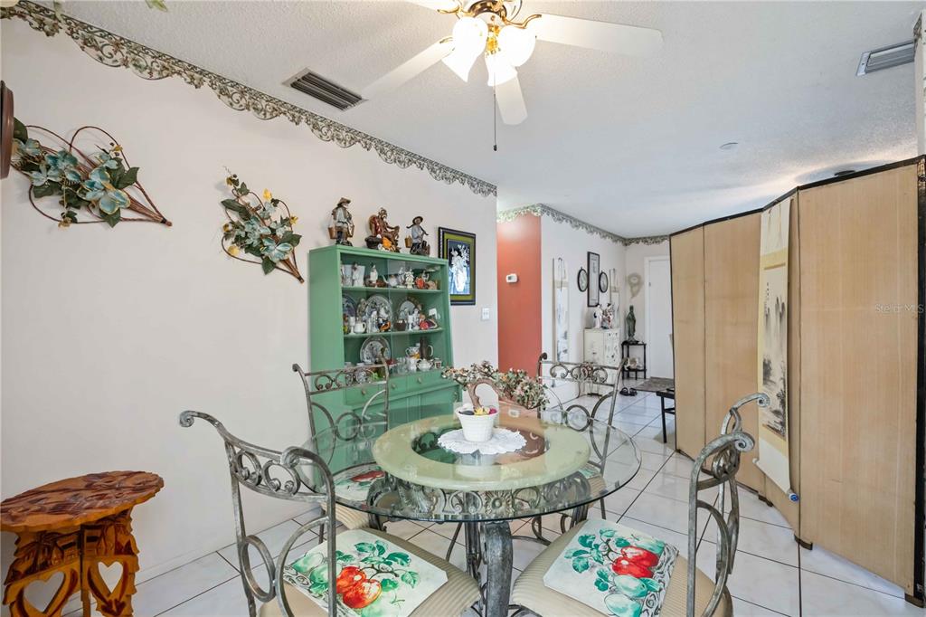 3801 Chinaberry Road Bradenton, FL 34208 - Photo 6 of 31 a view of a dining room with furniture and chandelier