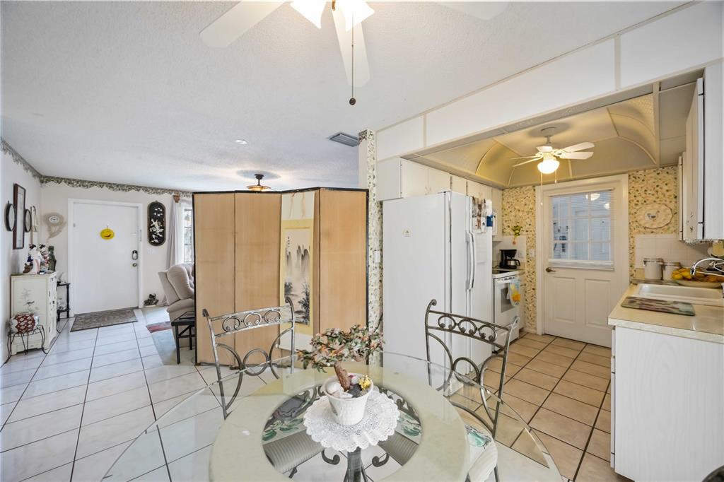 3801 Chinaberry Road Bradenton, FL 34208 - Photo 7 of 31 a living room with furniture and large windows