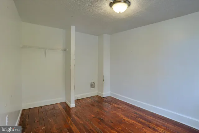 a view of an empty room and wooden floor