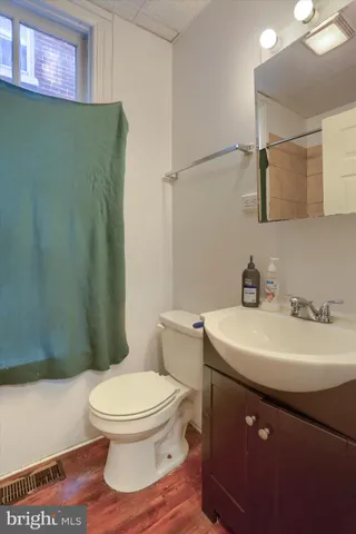 a bathroom with a sink toilet and a mirror