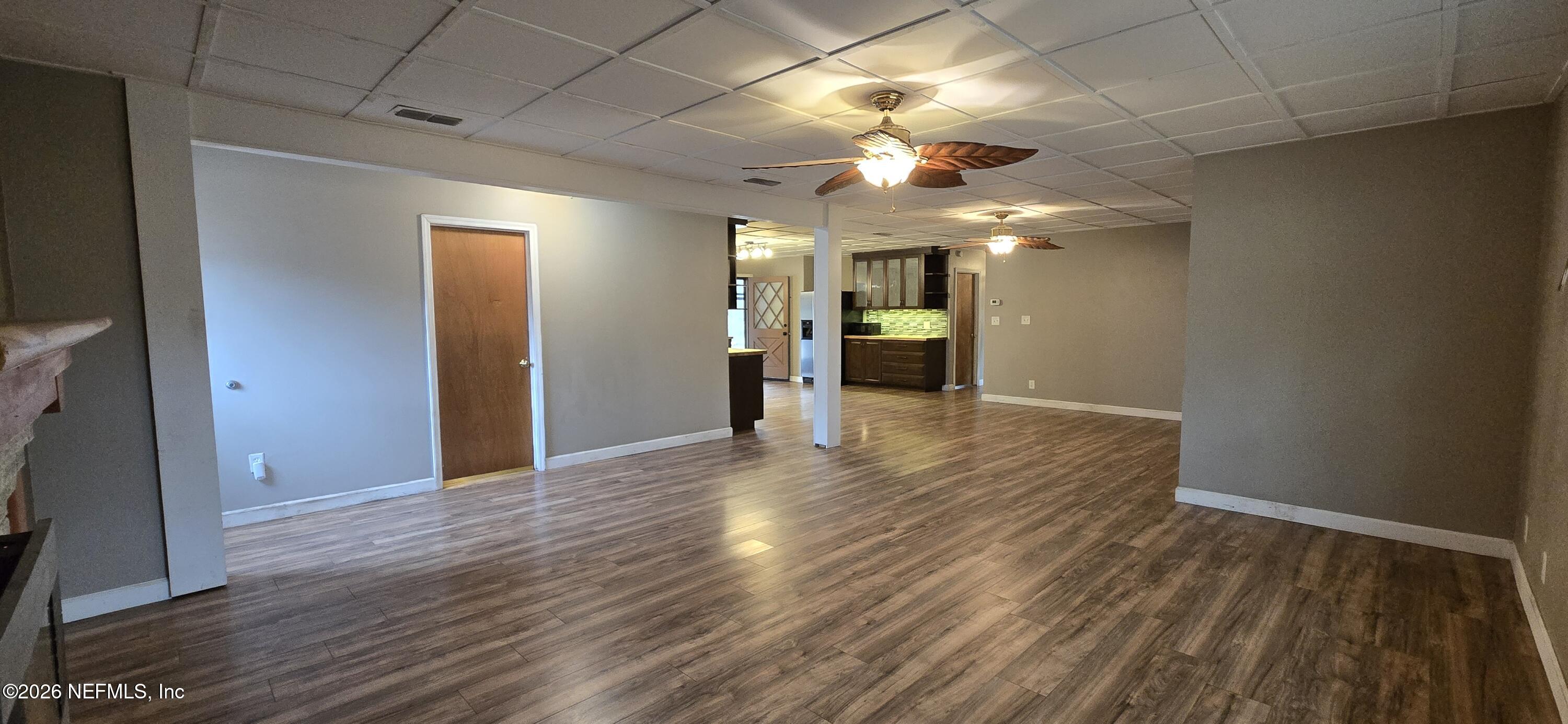 2720 Crystal Place Hilliard, FL 32046 - Photo 12 of 35 a view of an empty room with wooden floor and a ceiling fan