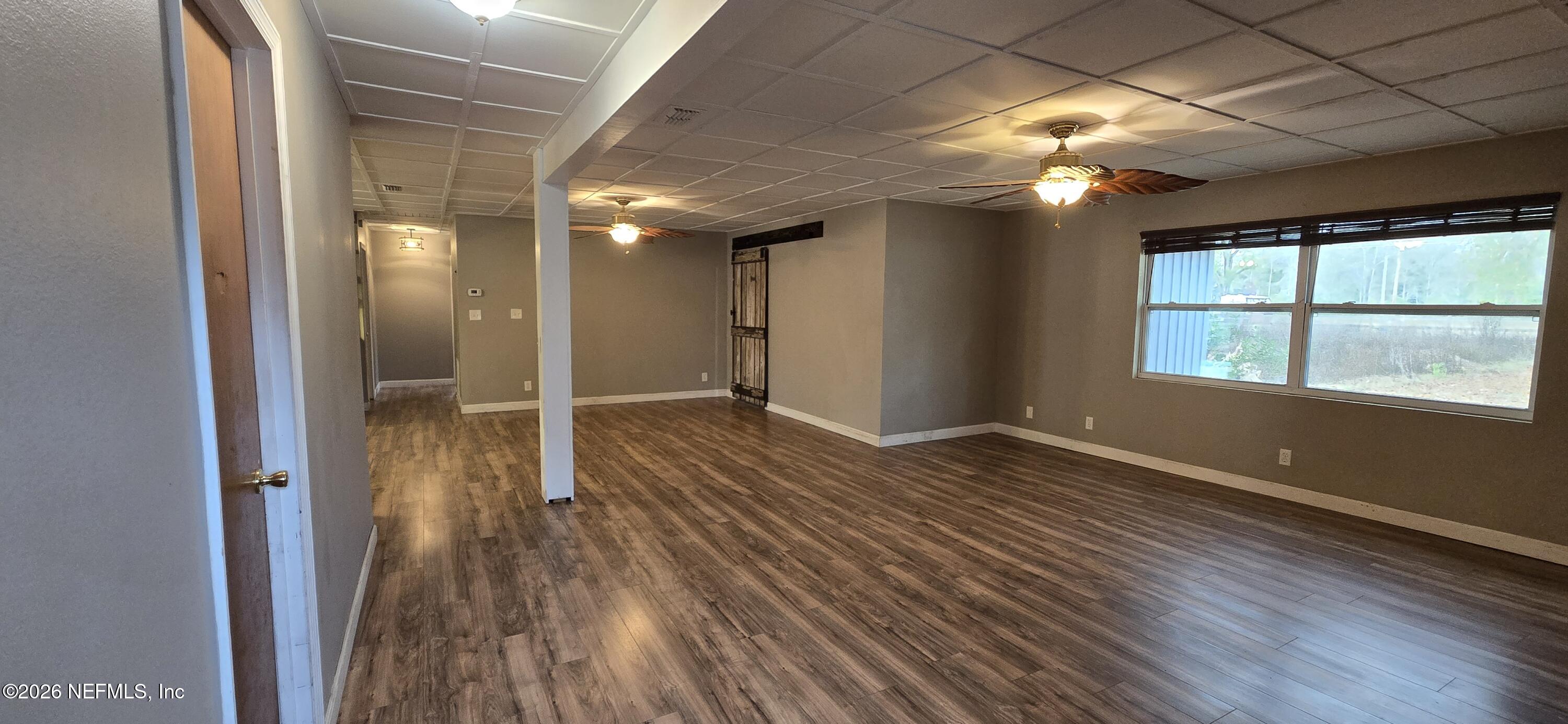 2720 Crystal Place Hilliard, FL 32046 - Photo 13 of 35 wooden floor in an empty room with a window