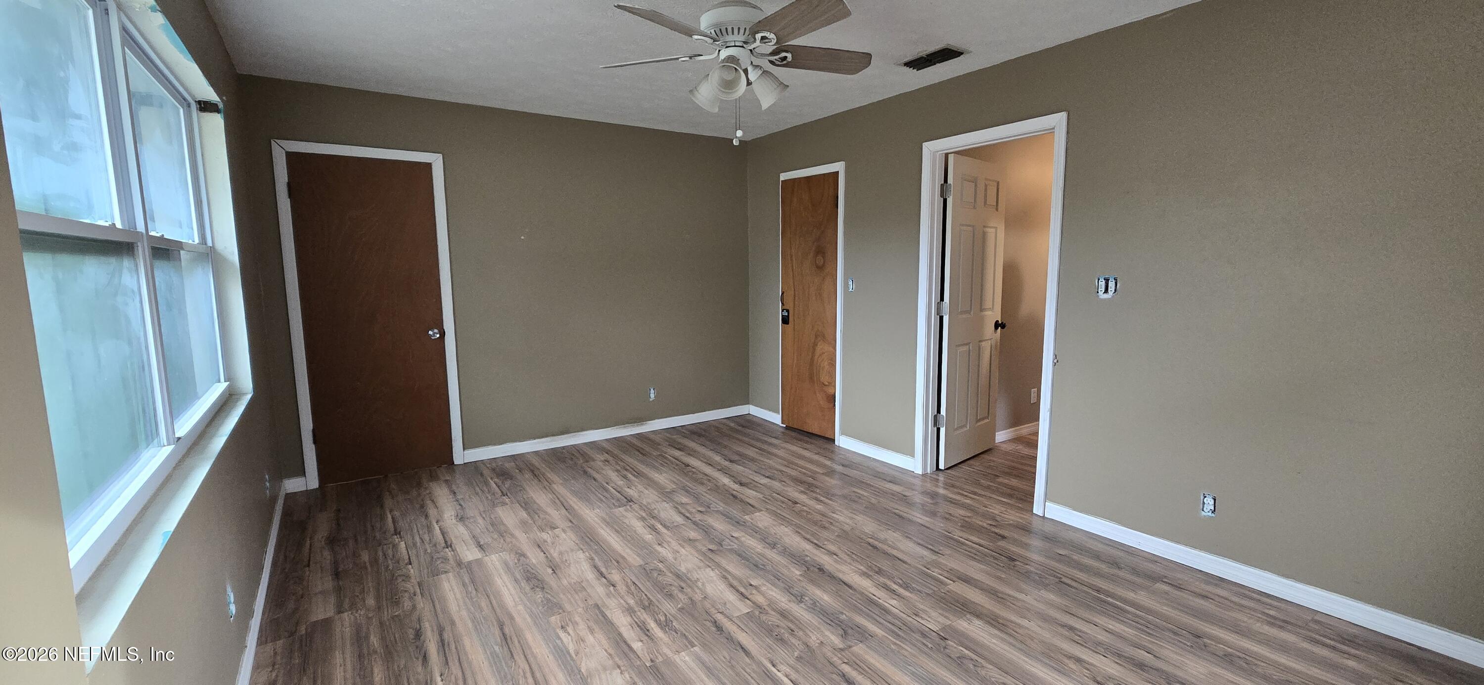 2720 Crystal Place Hilliard, FL 32046 - Photo 15 of 35 an empty room with wooden floor a ceiling fan
