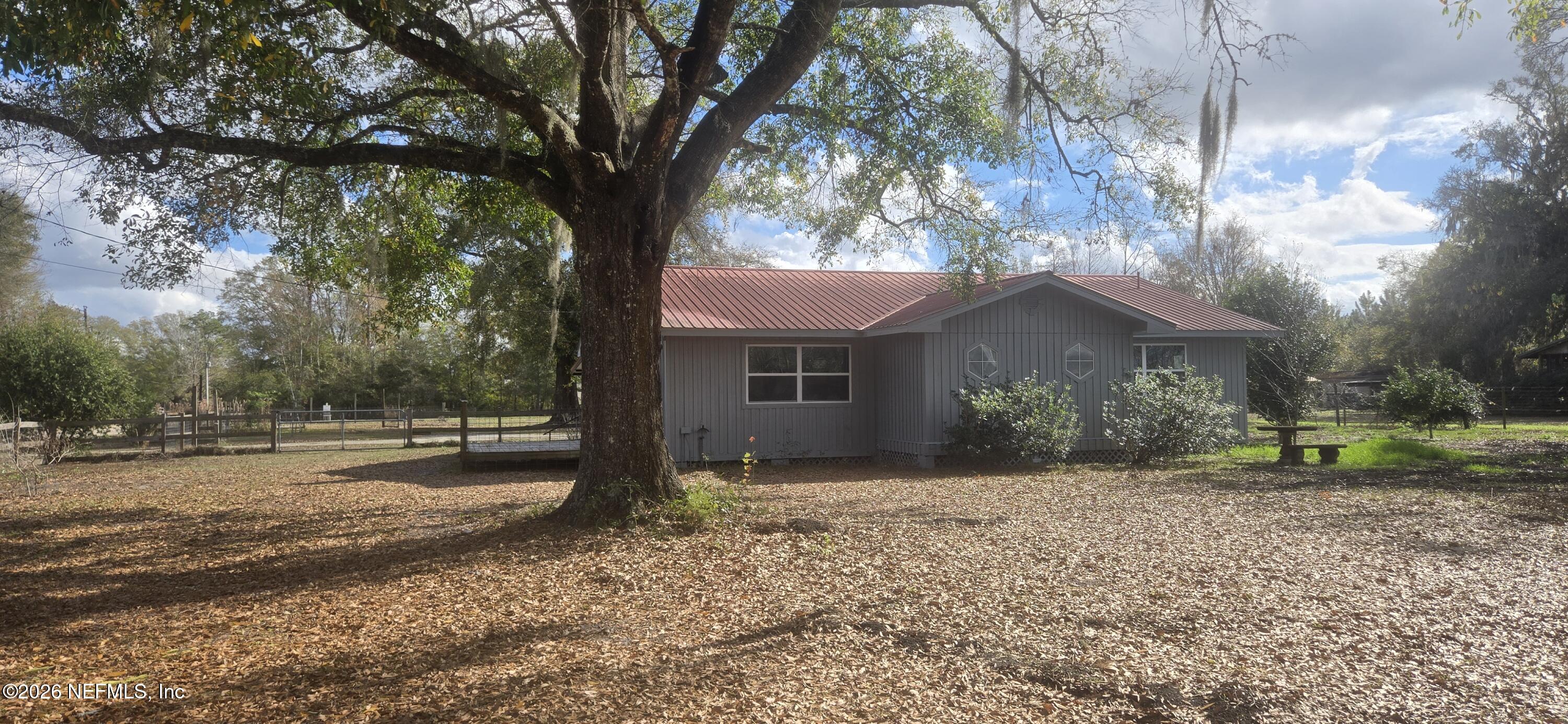 2720 Crystal Place Hilliard, FL 32046 - Photo 27 of 35 a front view of a house with a yard and garage