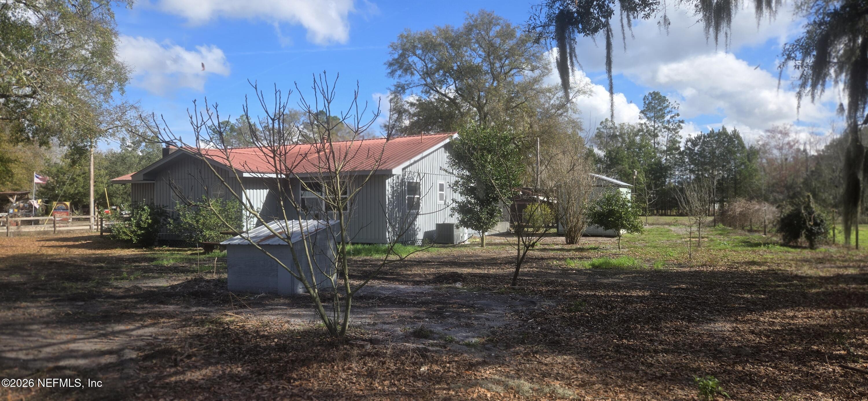2720 Crystal Place Hilliard, FL 32046 - Photo 31 of 35 a view of a house with backyard and a tree