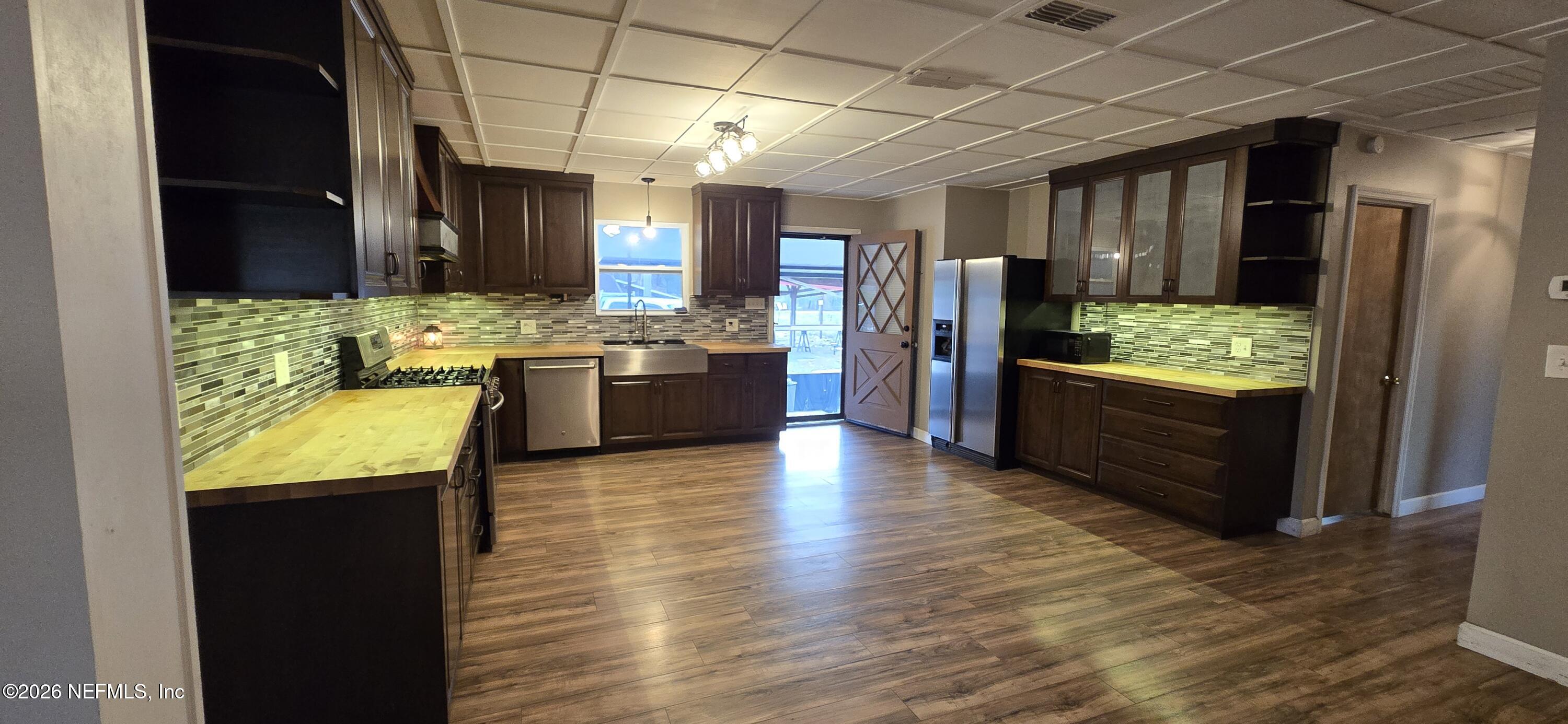 2720 Crystal Place Hilliard, FL 32046 - Photo 6 of 35 a view of kitchen with granite countertop stainless steel appliances stove refrigerator and cabinets