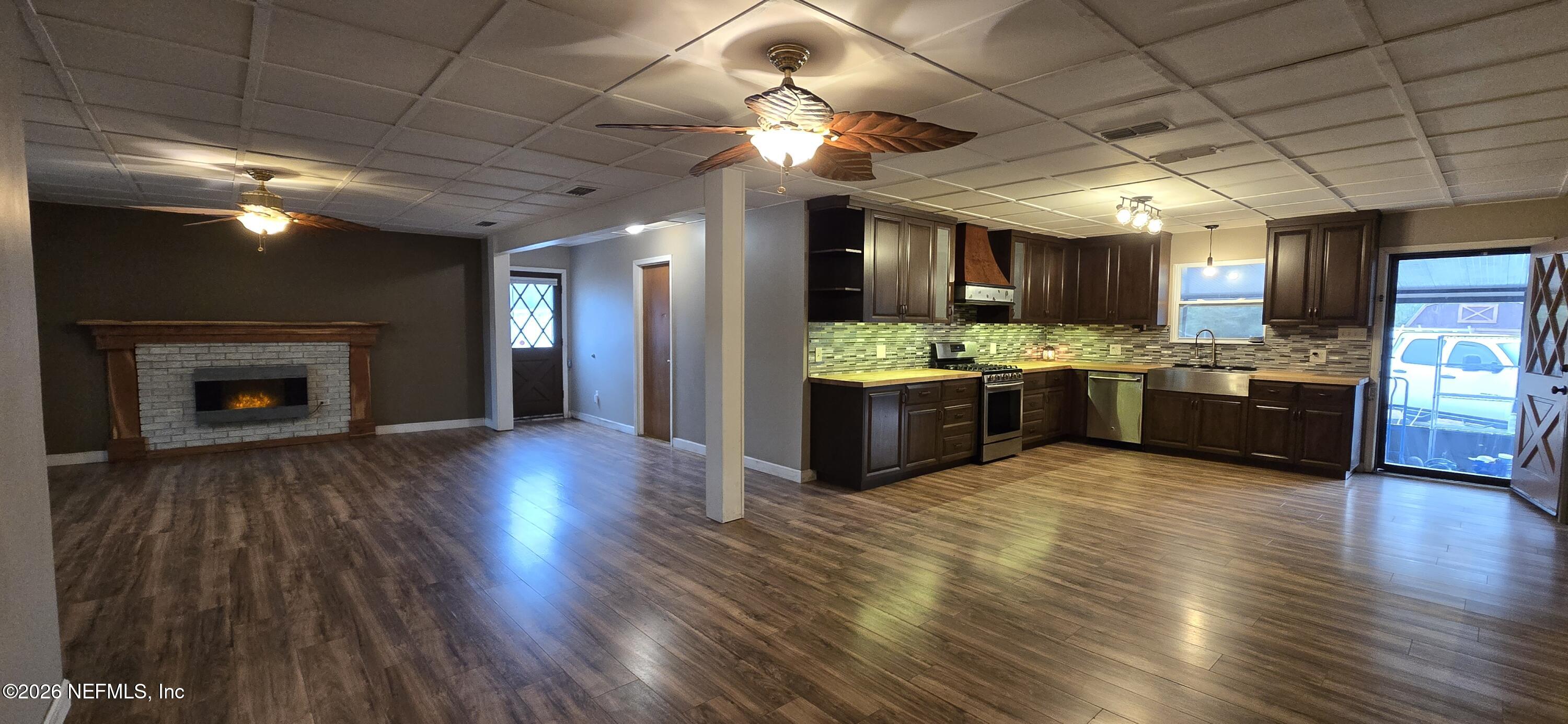 2720 Crystal Place Hilliard, FL 32046 - Photo 9 of 35 a view of kitchen with refrigerator stove and wooden floor