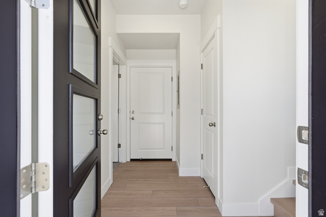 7338 South Seven Tree Lane, Unit 75 Midvale, UT 84047 - Photo 4 of 30 Hall with light wood-style flooring and baseboards