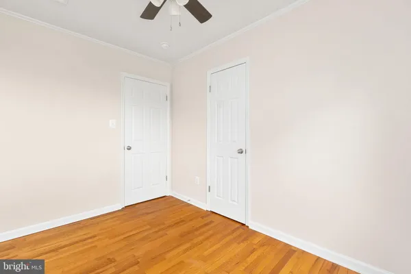 a view of a room with a window and a ceiling fan
