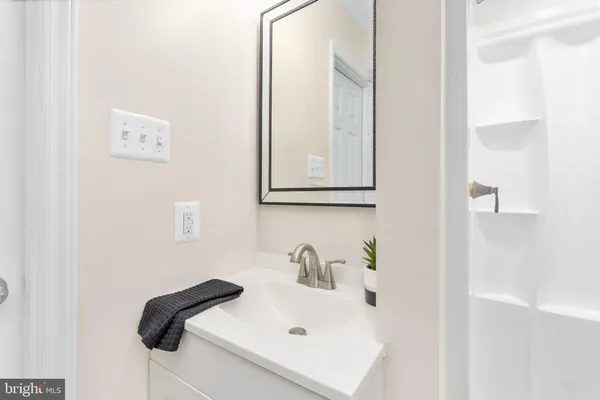 a bathroom with a sink and a mirror