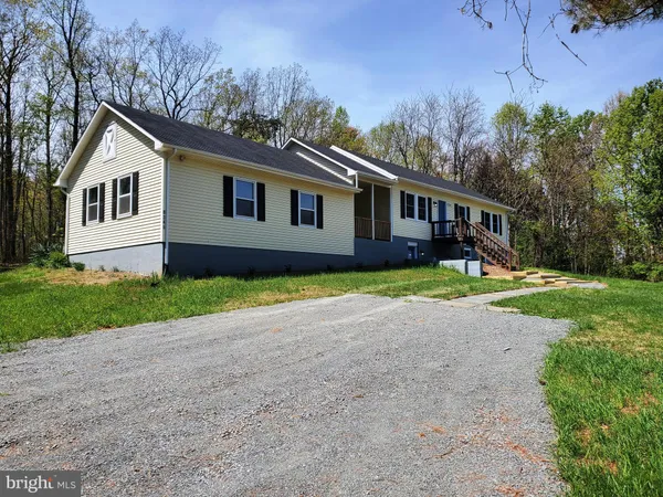 a house that has a tree in front of the house