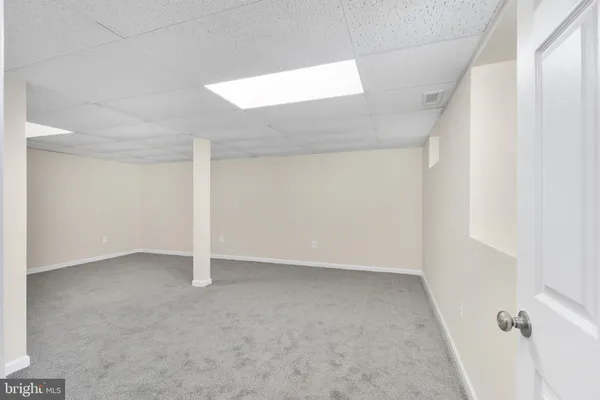 an empty room with a empty space and windows