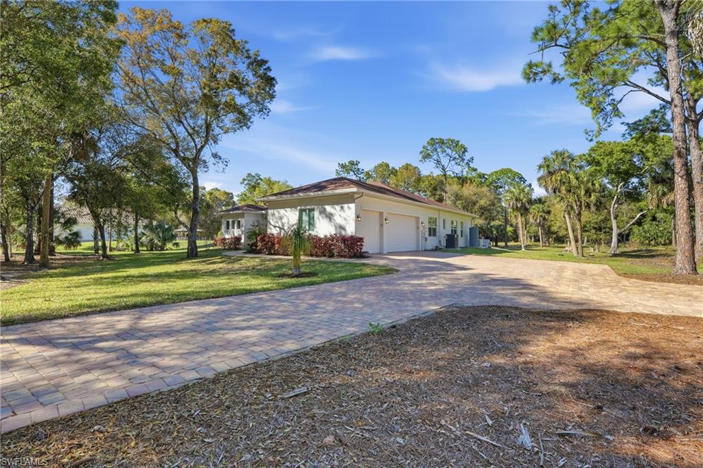 3707 5th Avenue Southwest Naples, FL 34117 - Photo 41 of 45 Long paver driveway, three-car garage and extra parking pad