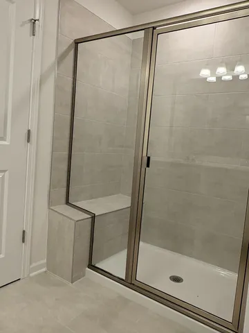 a bathroom with a glass shower door