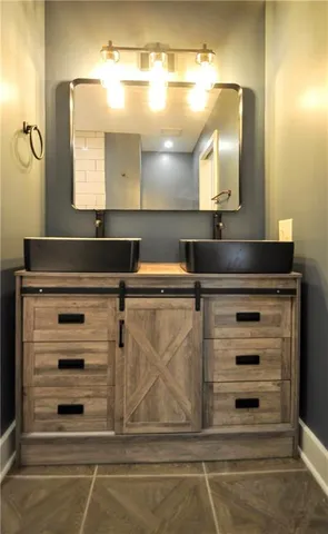 a bathroom with a mirror and a sink