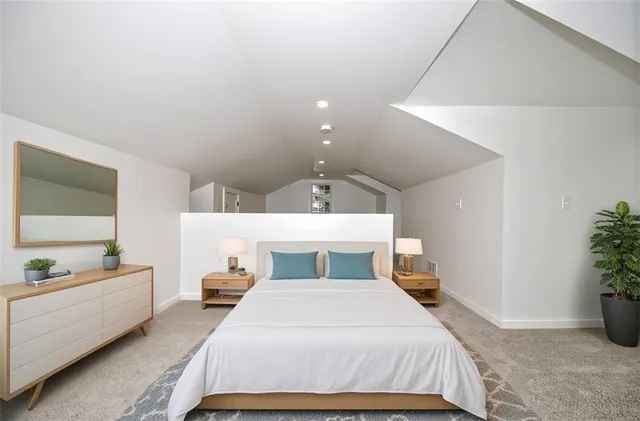 a bedroom with a bed and a potted plant