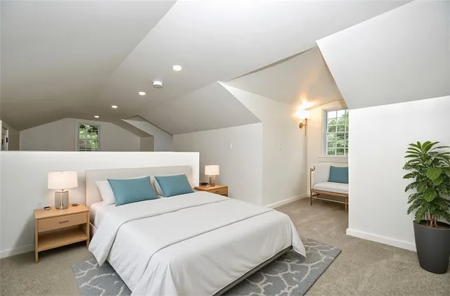 a bedroom with a bed and a potted plant