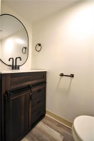 a bathroom with a sink a toilet and mirror