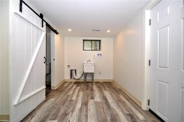 a view of a room with wooden floor and white walls