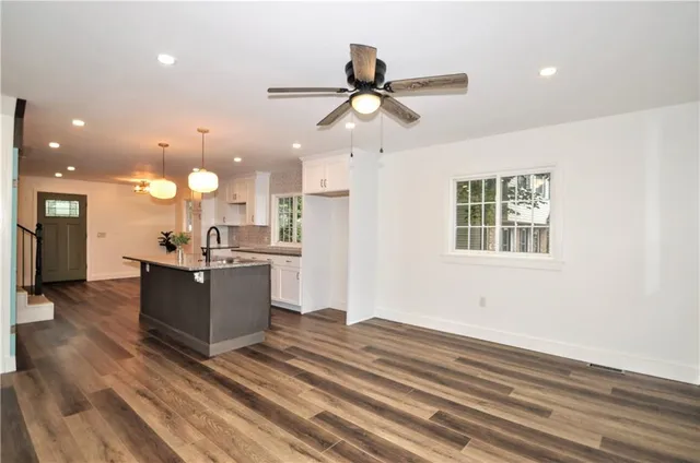 a view of kitchen with sink microwave and stove