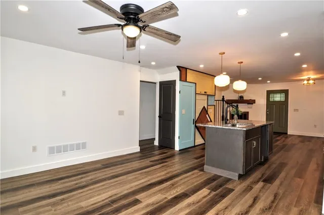 a view of a kitchen counter top space with furniture and wooden floor