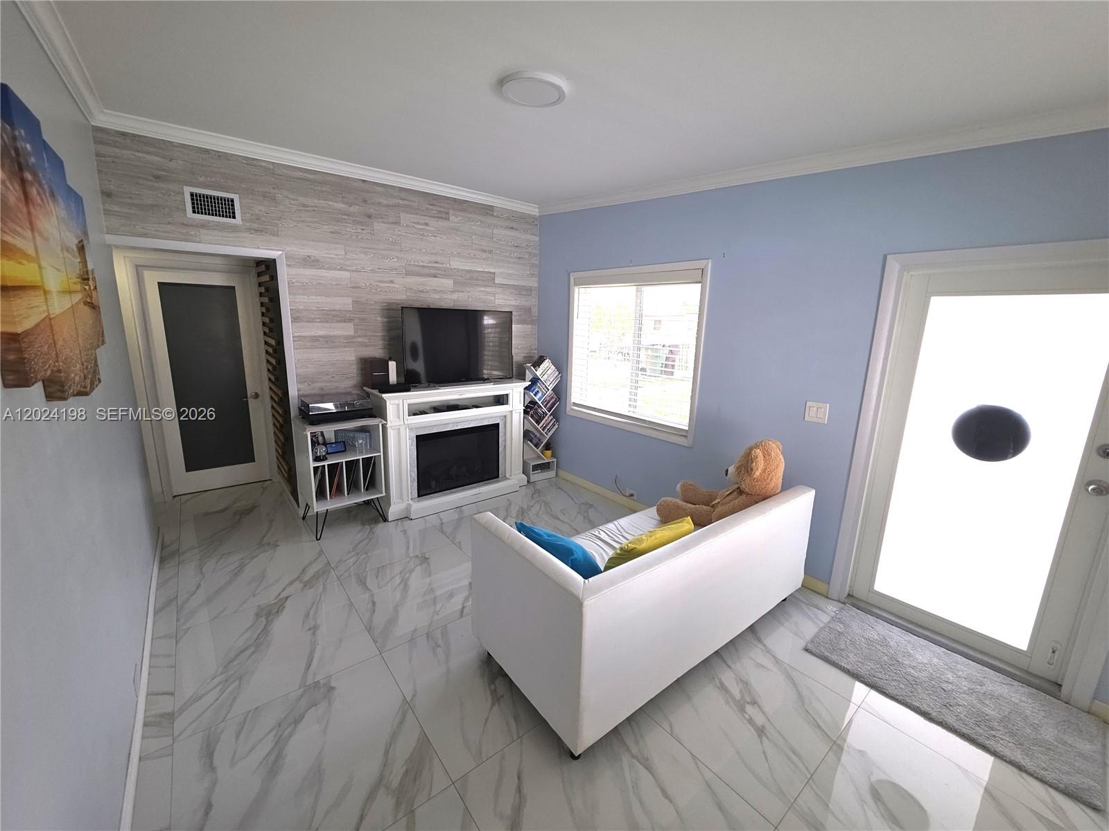 651 East 48th Street Hialeah, FL 33013 - Photo 6 of 52 a living room with furniture and a flat screen tv