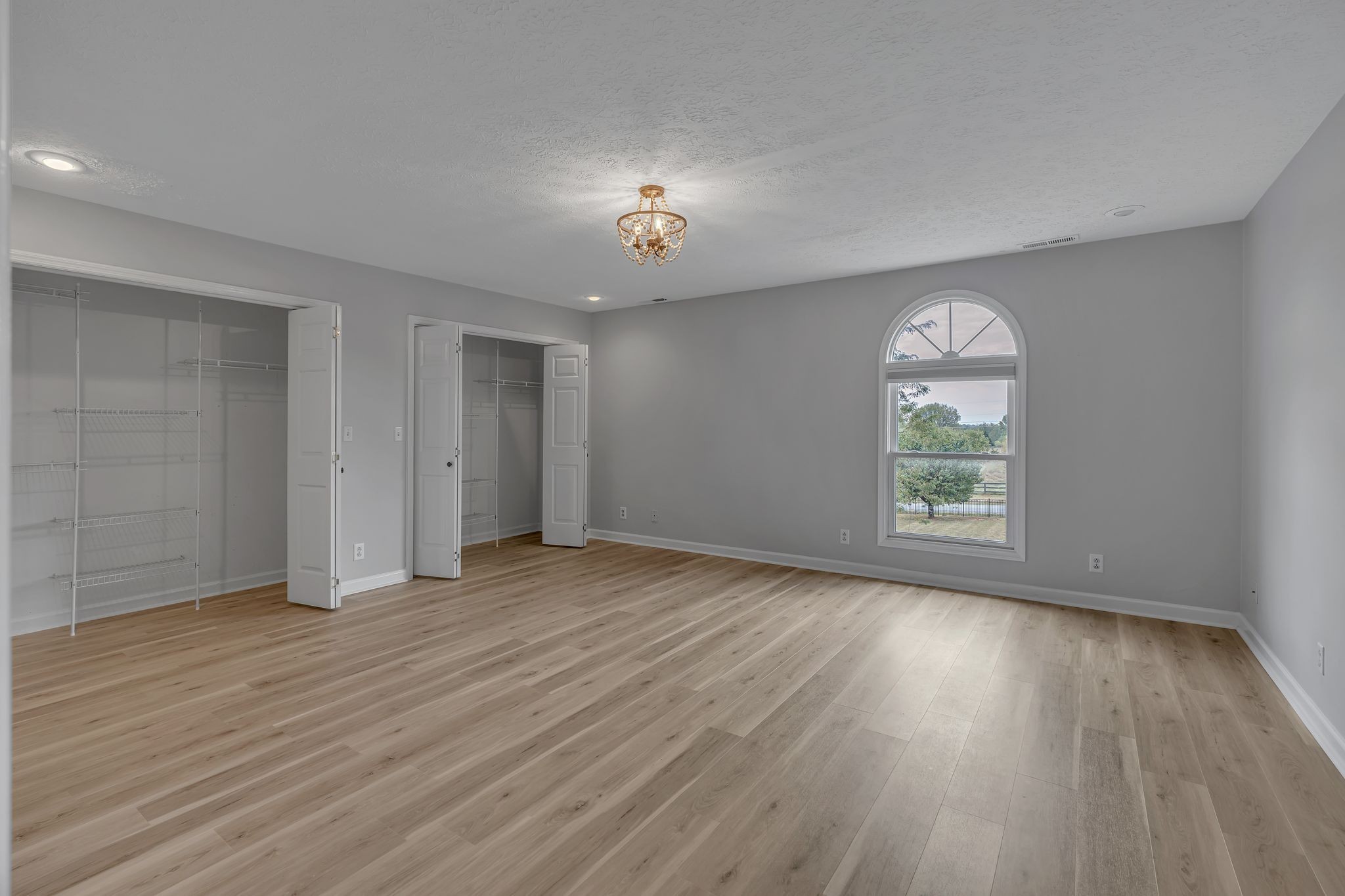 2103 Liebengood Road Goodlettsville, TN 37072 - Photo 52 of 97 an empty room with wooden floor chandelier and windows