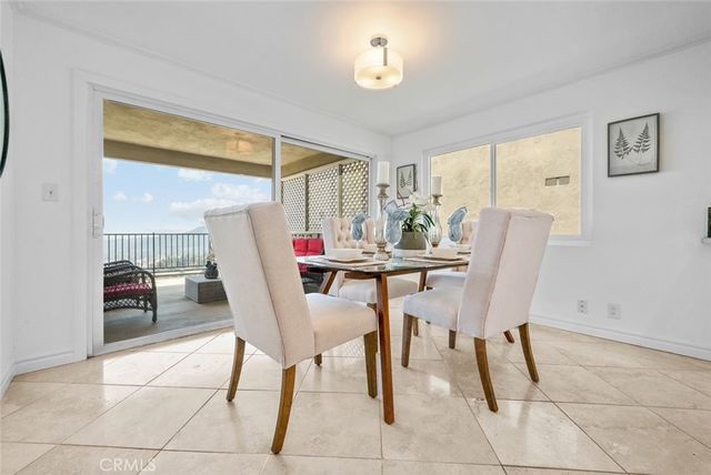 a view of a dining room with furniture and a chandelier