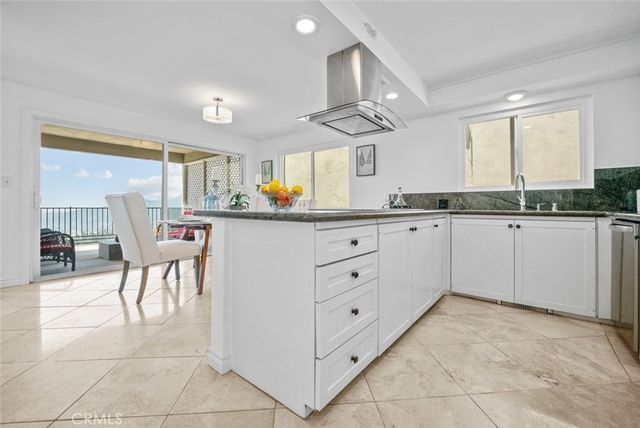 a kitchen with a sink a counter top space cabinets and appliances