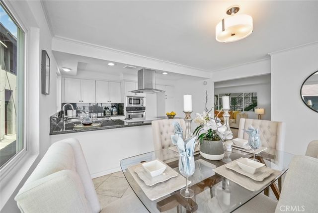 a living room with furniture kitchen and a chandelier