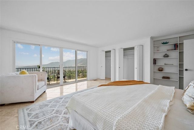 a bedroom with a large bed and a large window