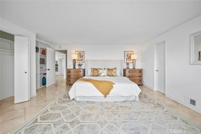 a spacious bedroom with a bed and a couch