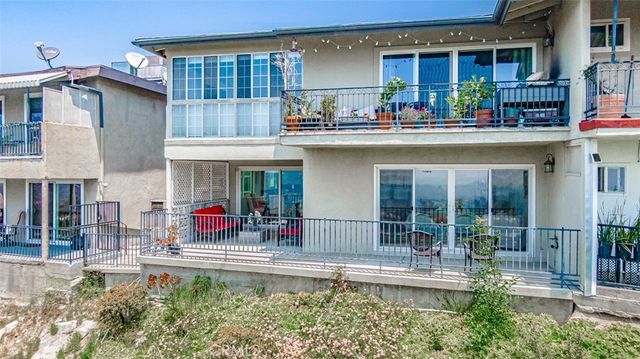 a view of a swimming pool with a bench in front of building