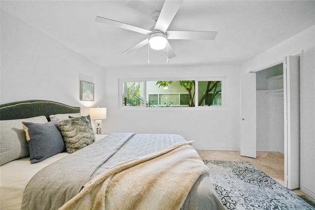 a bedroom with a large bed and a window