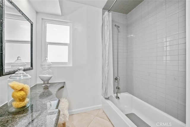 a bathroom with a tub shower and sink