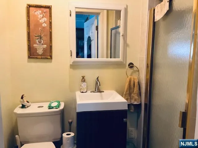 a bathroom with a sink mirror and toilet