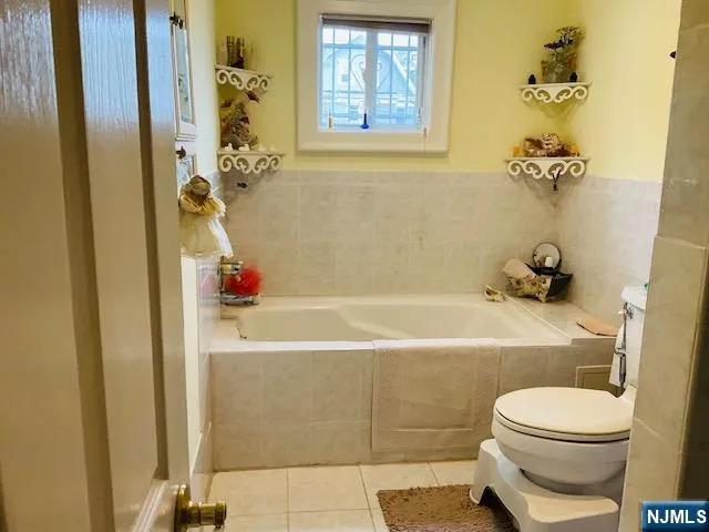 a bathroom with a bathtub a toilet and a shower