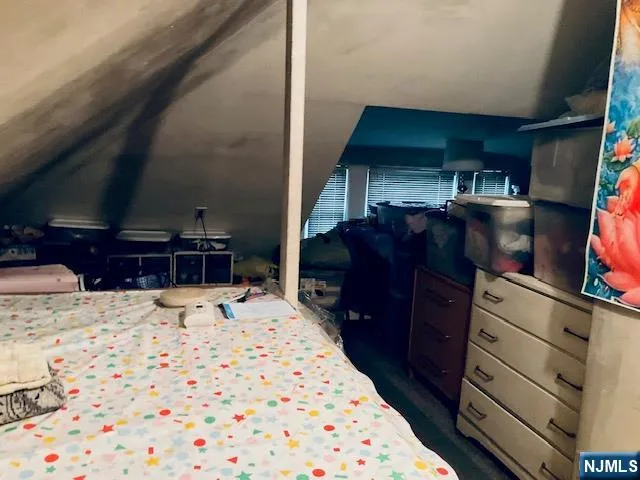 a bed room with a bed and a television