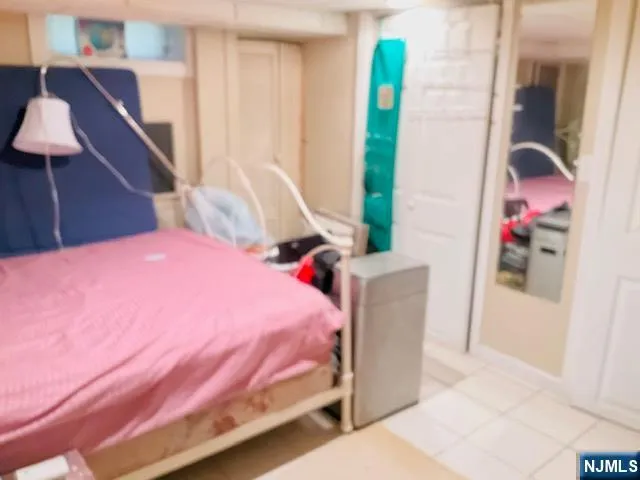 a bedroom with a bed and a potted plant