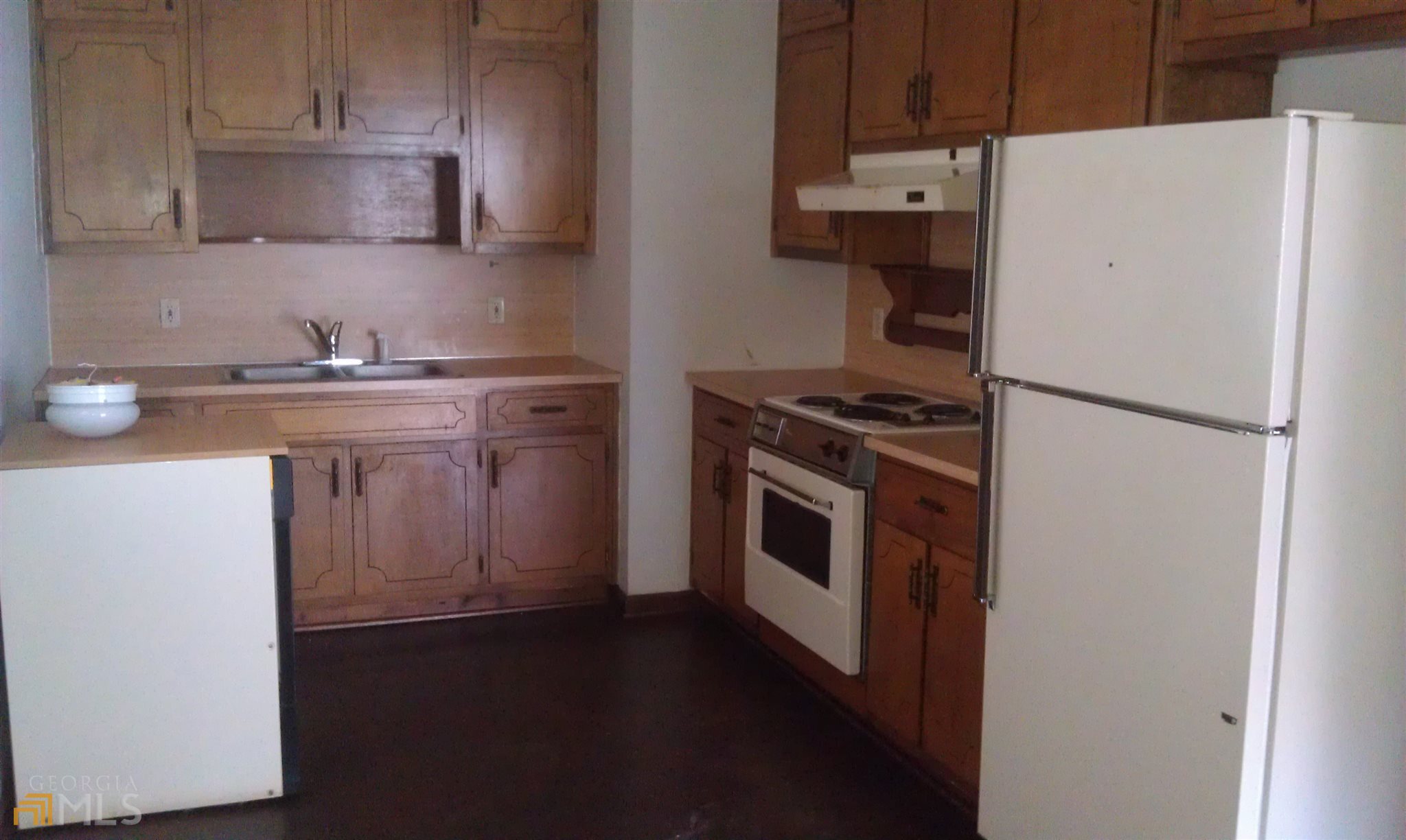 565 Womack Road Covington, GA 30016 - Photo 2 of 4 a kitchen with a stove top oven and sink