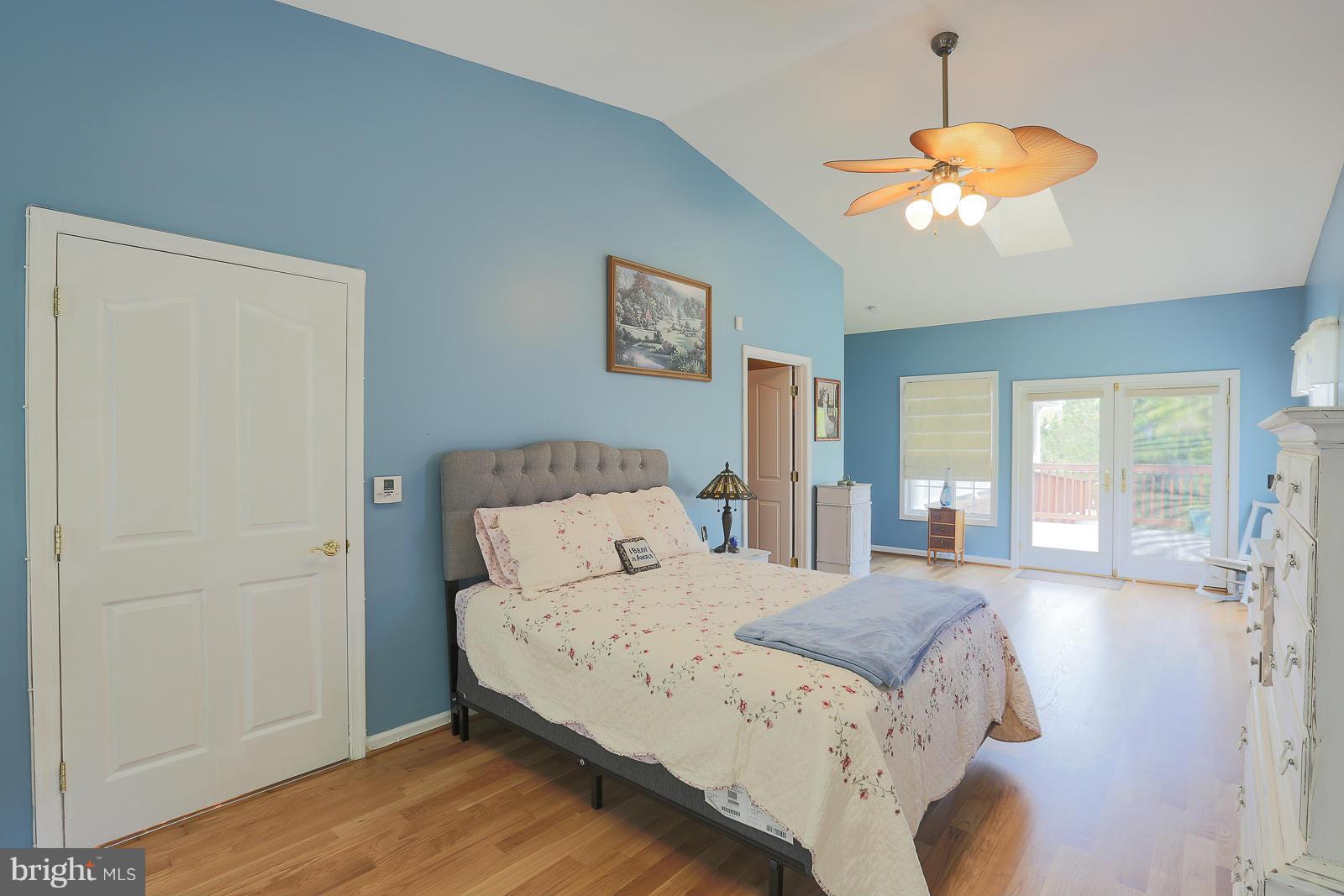 5020 Forge Road Perry Hall, MD 21128 - Photo 22 of 30 a bedroom with a large bed and a chandelier