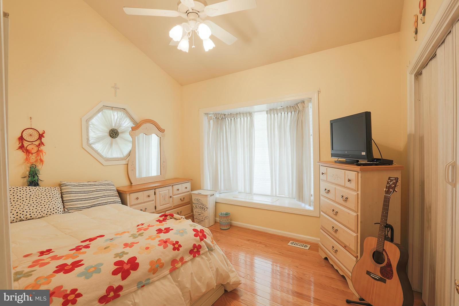 5020 Forge Road Perry Hall, MD 21128 - Photo 26 of 30 a bedroom with a bed and a flat tv screen on dresser